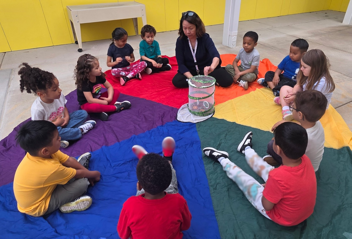 Grace Luy and the children in her class learn about butterflies during whole-group time.