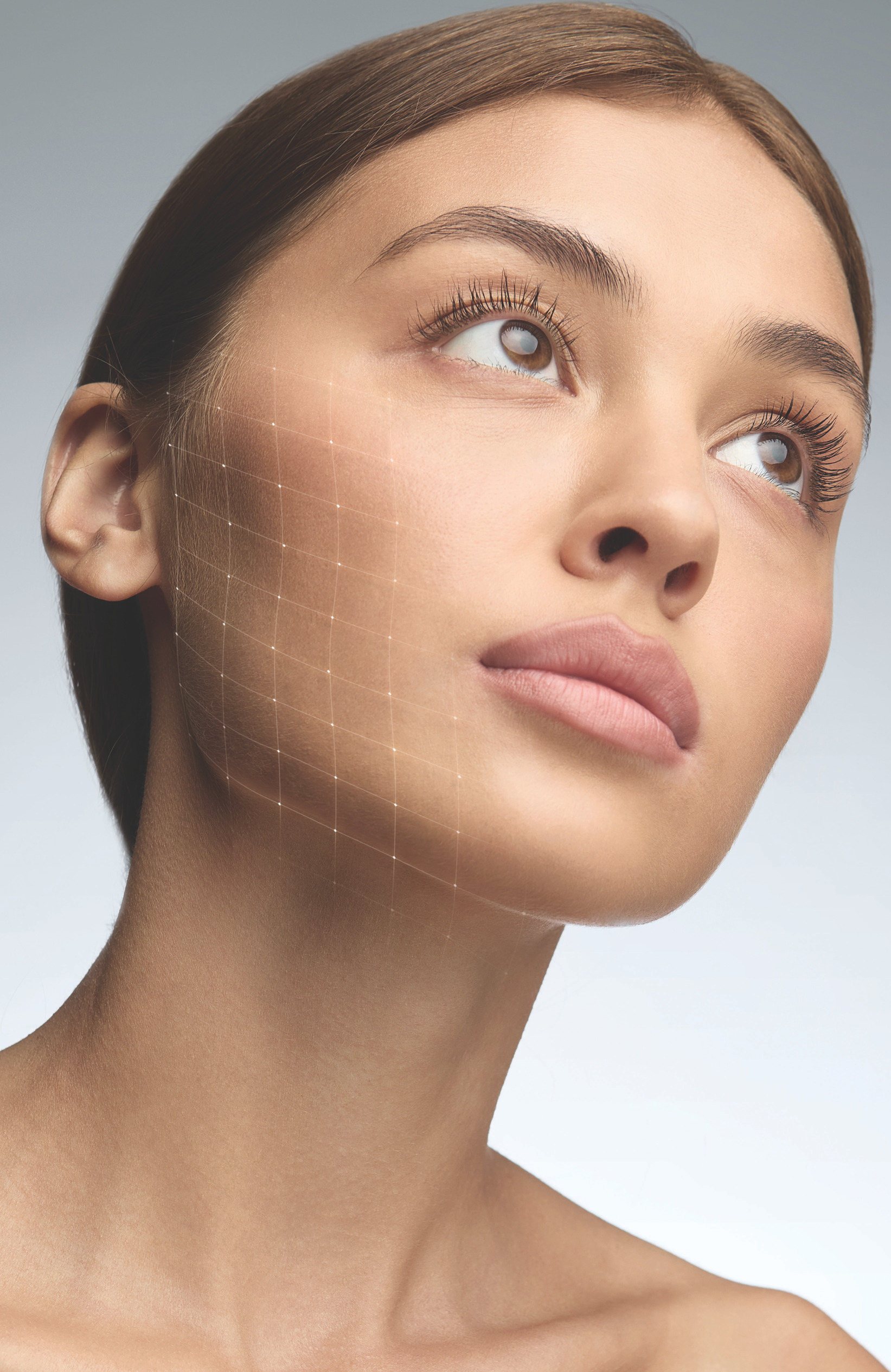 Portrait of a young woman with a subtle grid overlay on her cheek