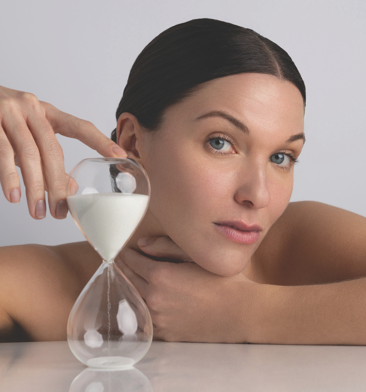 Woman holding an hourglass to convey passage of time