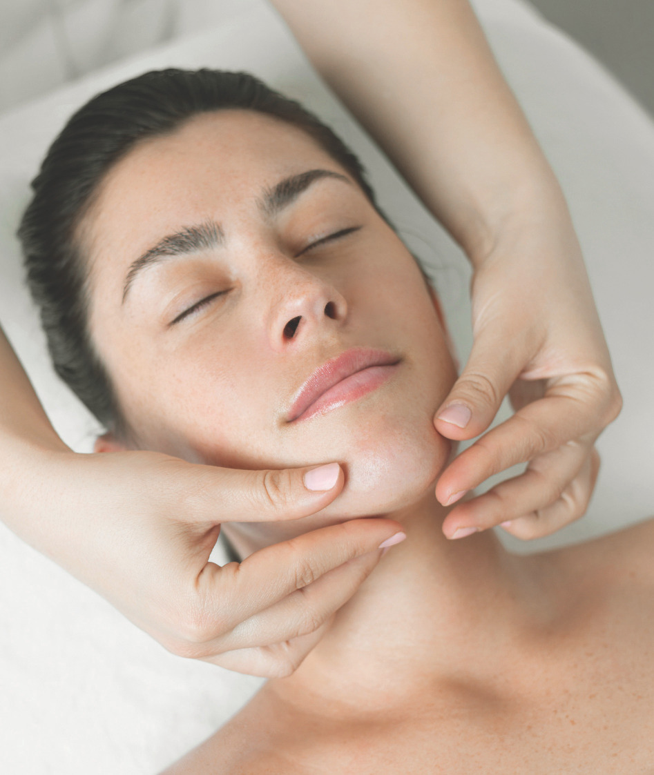 Client receiving a facial treatment on a spa table