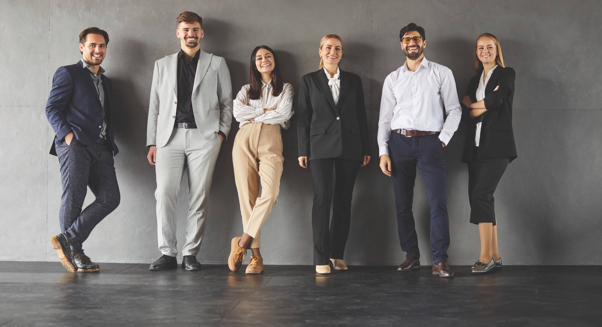 Group of six professionals in business attire standing together