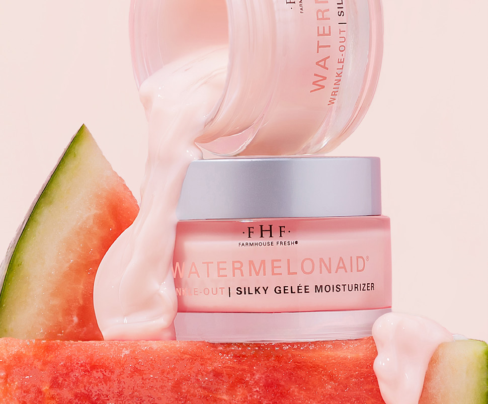 Watermelonaid Silky Gel&eacute;e moisturizer pouring from its jar over a slice of watermelon