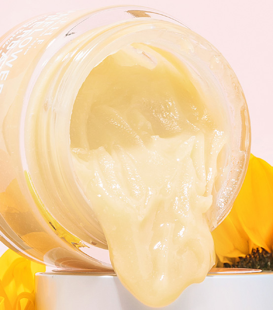 Jar turned on its side with pale cream pouring out