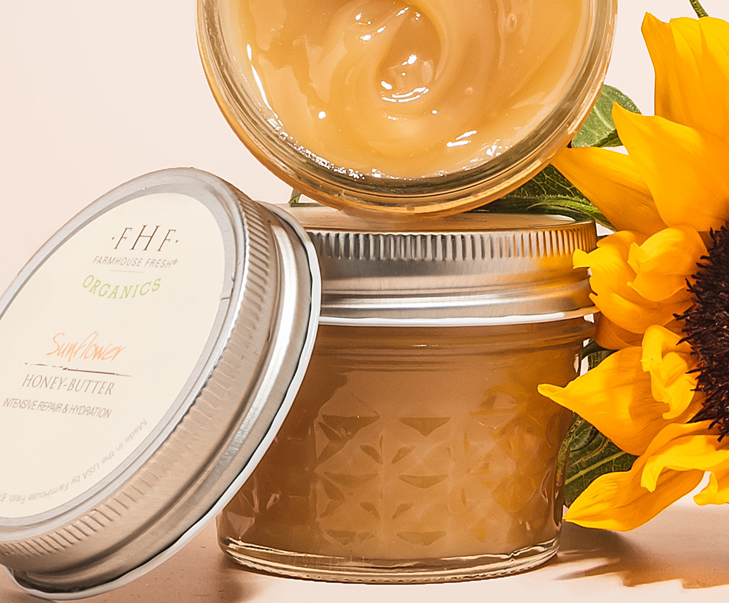Open jar of balm with sunflower petals (top view)