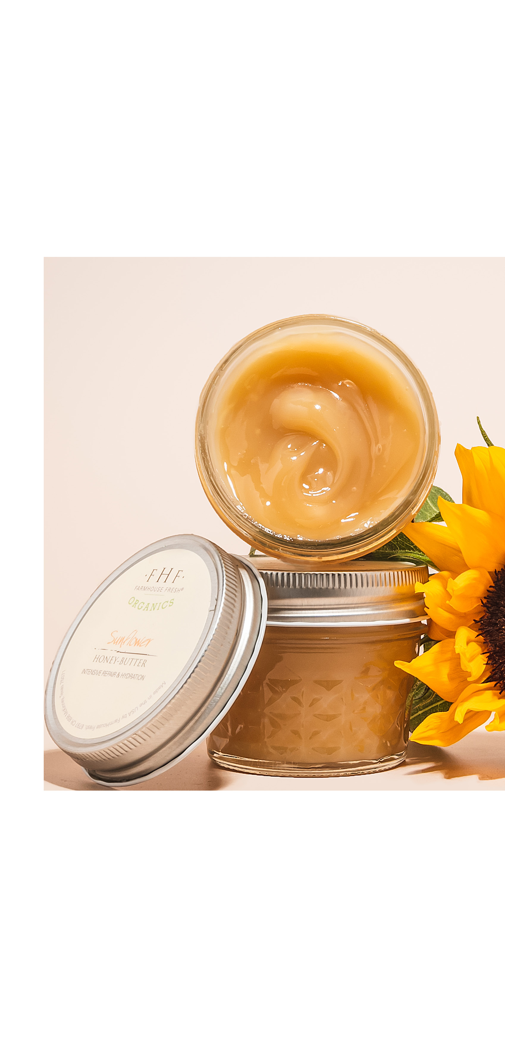 Stacked jars of golden balm with sunflower bloom