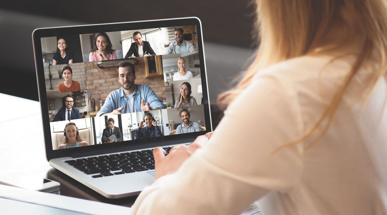 Laptop showing a multi-person video conference of industry experts