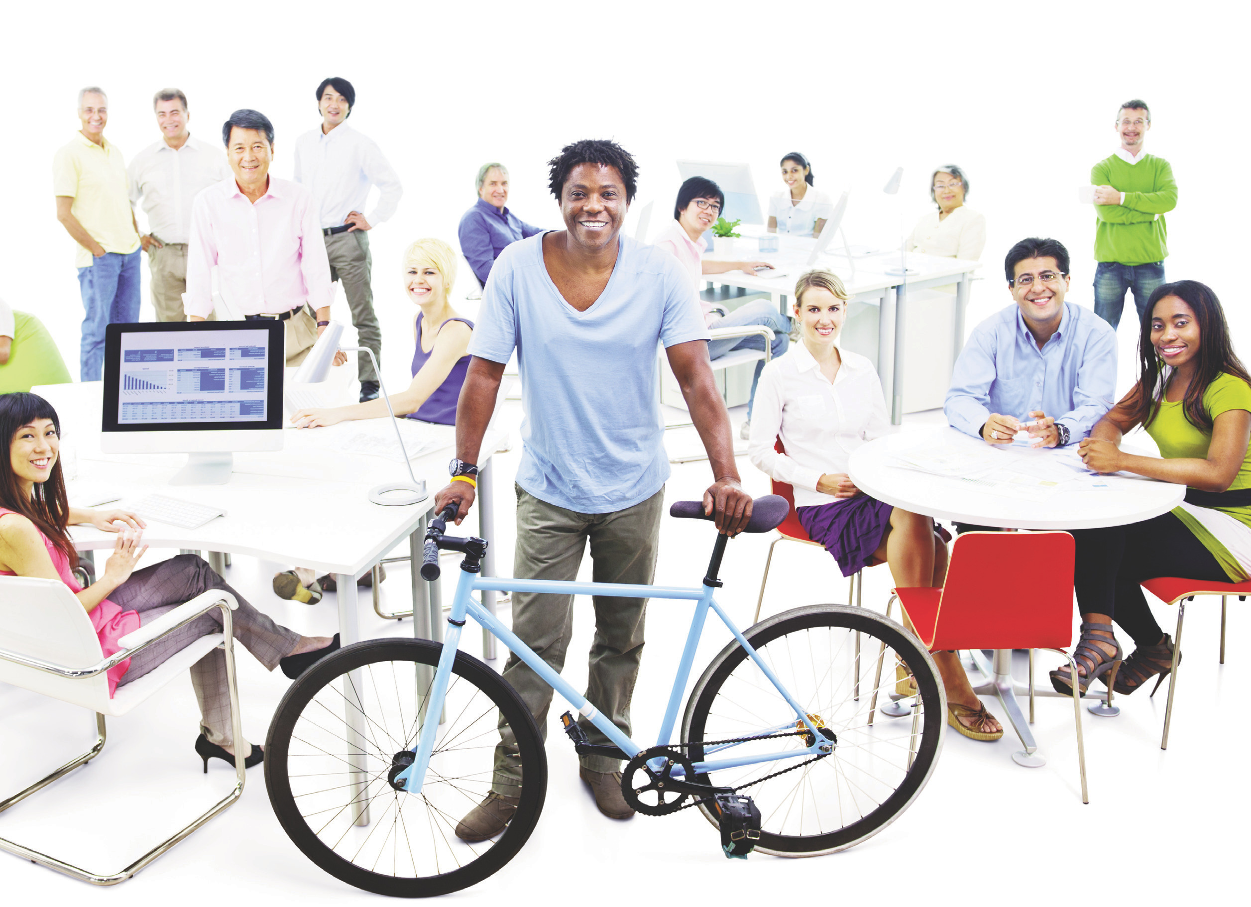 Group of spa team members in a bright office; a man stands in the foreground holding a bicycle with colleagues at tables behind him.