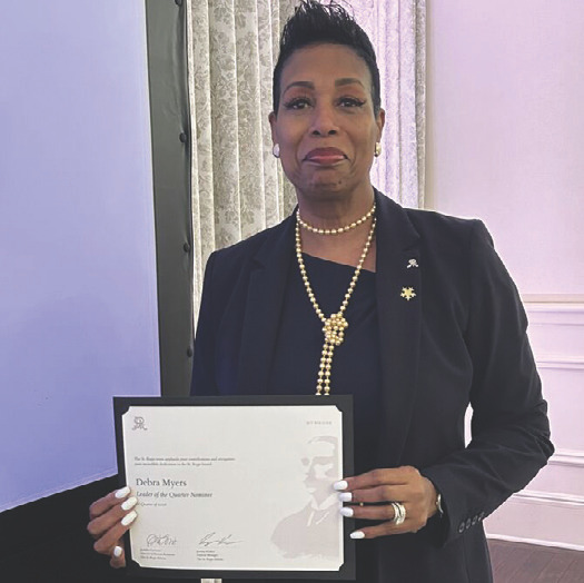 Debra Myers holding a certificate