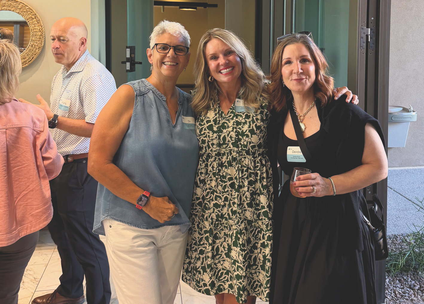 Three women posing together at the ISPA Connect reception, smiling in an indoor reception setting