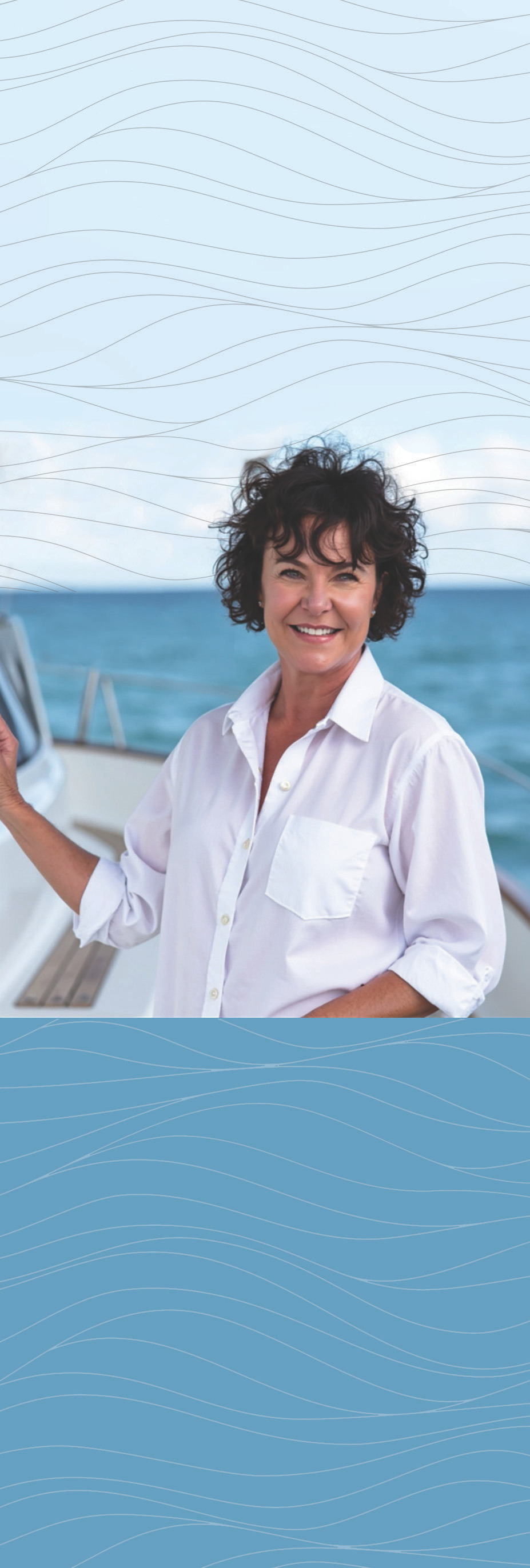Smiling person standing on a boat with ocean visible in the background