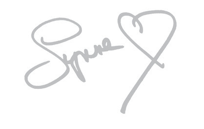Handwritten signature with a small heart