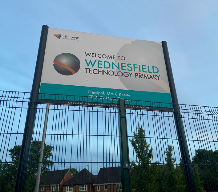 Welcome to Wednesfield Technology Primary School entrance sign with fencing