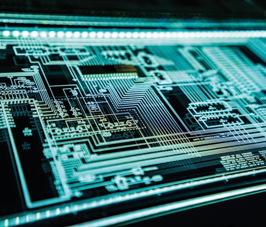 Close-up image of a printed circuit board representing electronic systems.