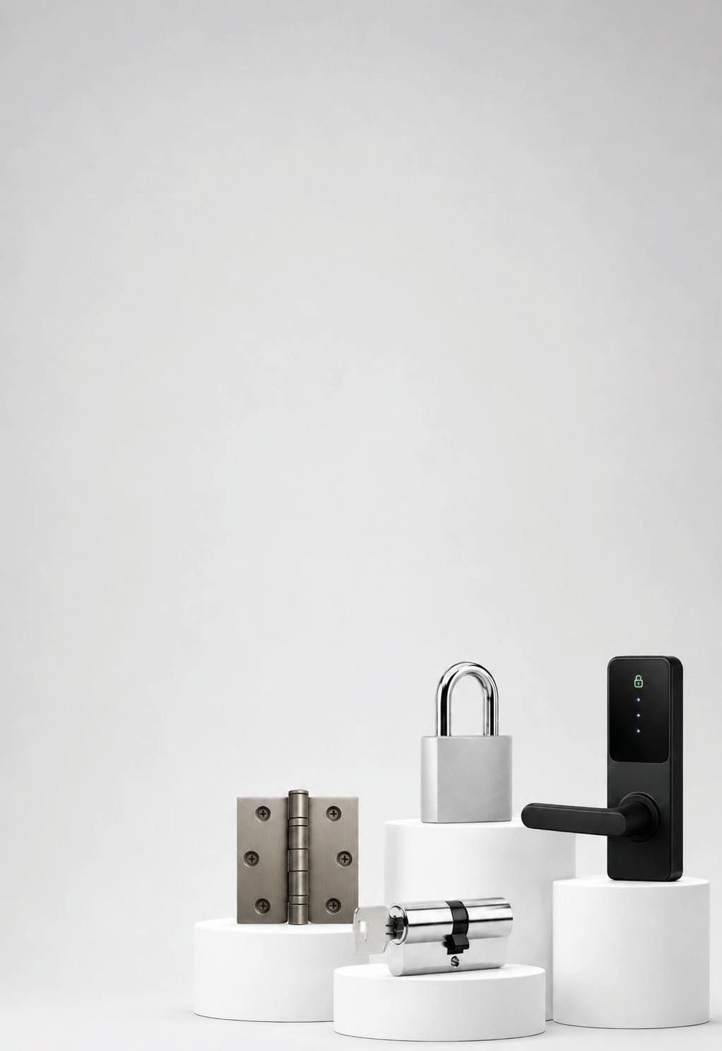 Assorted door hardware including hinge, cylinders and smart door handle on white plinths