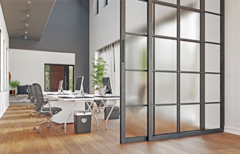 Interior office area with black metal-framed sliding glass partition