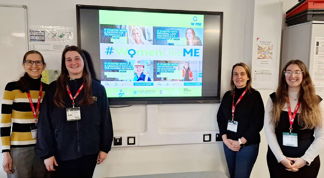 Four women from Endurance&reg; Doors and WiME standing in front of a presentation screen displaying the #WomenLikeME campaign