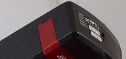 Close-up detail of a LiftMaster actuator bracket / component end with red accent.