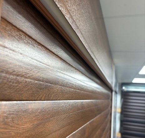 Close-up detail of wood‑grain roller door slats showing texture and profile