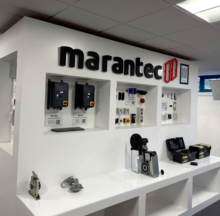 Marantec showroom display showing motors and control panels mounted on a white wall