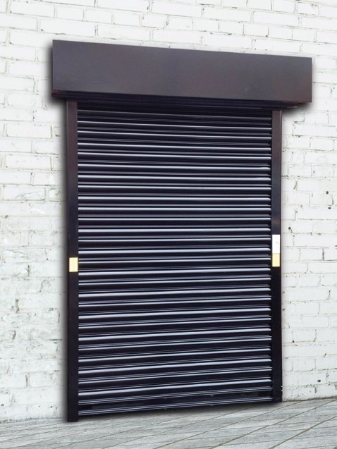 Black roller shutter fitted to a white brick wall (closed shutter with pelmet)