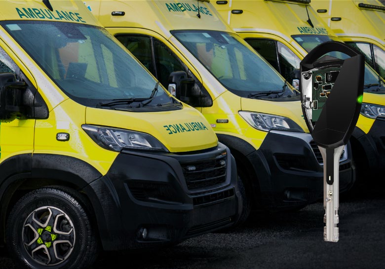 Row of yellow East Midlands ambulances with an overlaid PROTEC2 CLIQ electromechanical key and cylinder