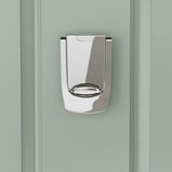 Close-up of a polished silver door knocker or letterplate on a mint-green door.