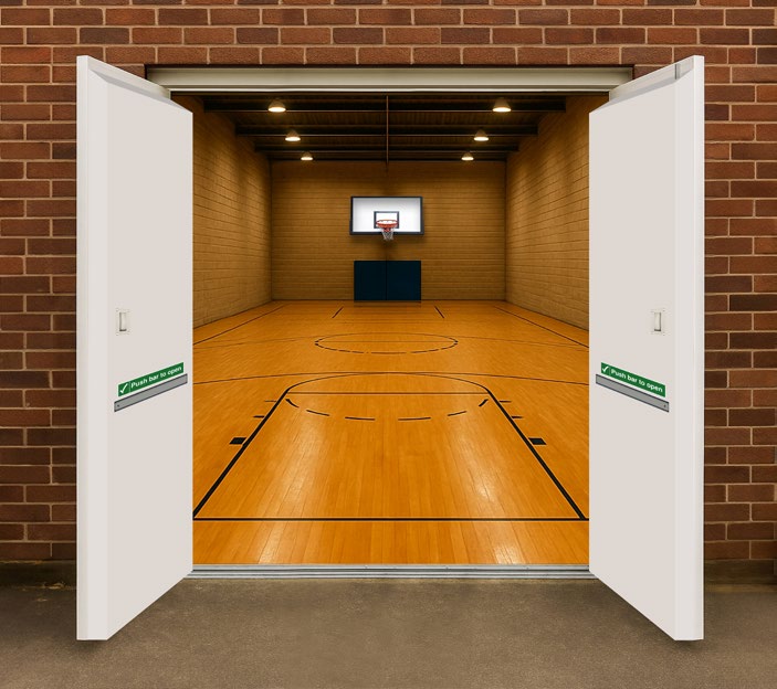 Open white ACTIV-DOR doors opening onto a brightly lit indoor basketball court