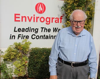 Derek Ward, founder of Envirograf, standing beside an Envirograf sign
