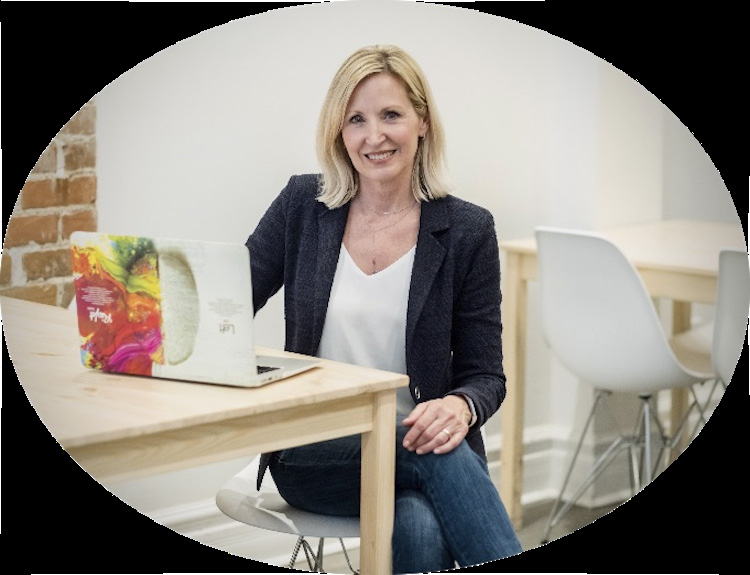 Oval portrait of Ann Papayoti seated at a desk