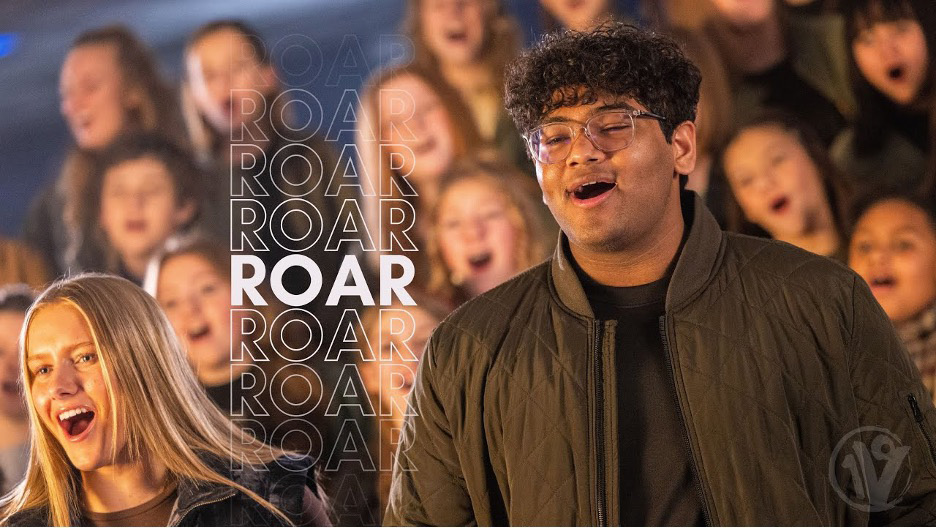 Members of One Voice Children's Choir and lead singer performing; album art for 'ROAR' with choir in background