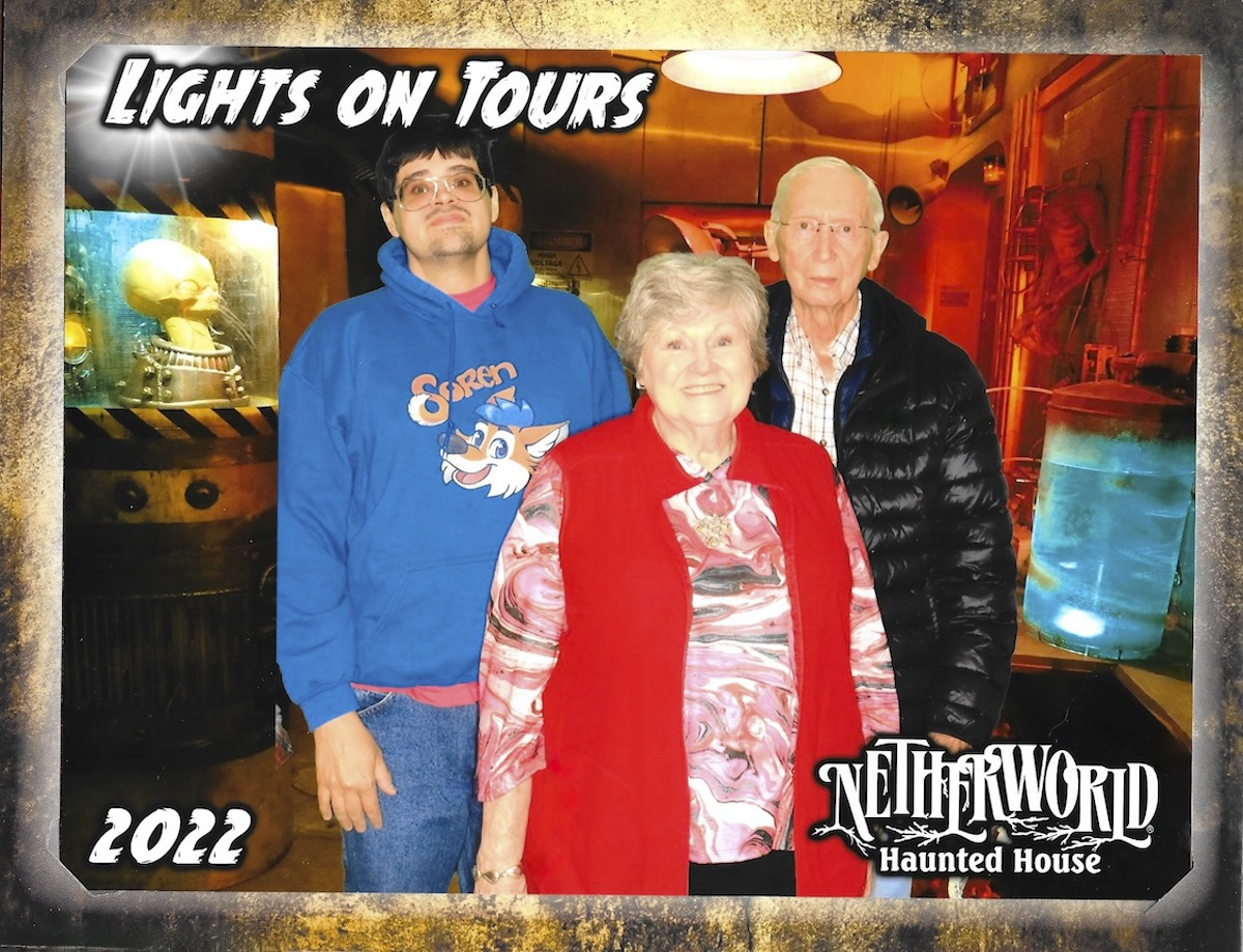 Group photo titled 'Lights on Tours' showing three people