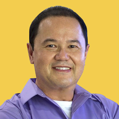 Author headshot of Johnny Tan smiling