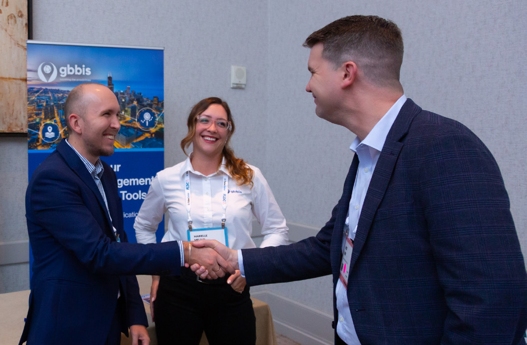 Attendees networking and shaking hands at the event